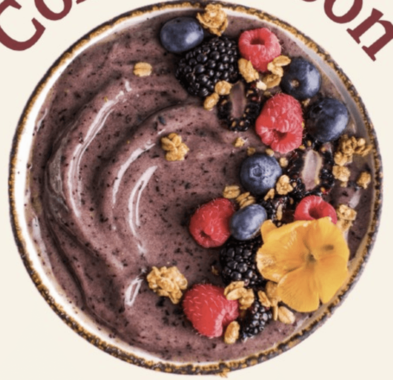 Soulberry açaí bowl topped with blueberries, granola, and an edible flower
